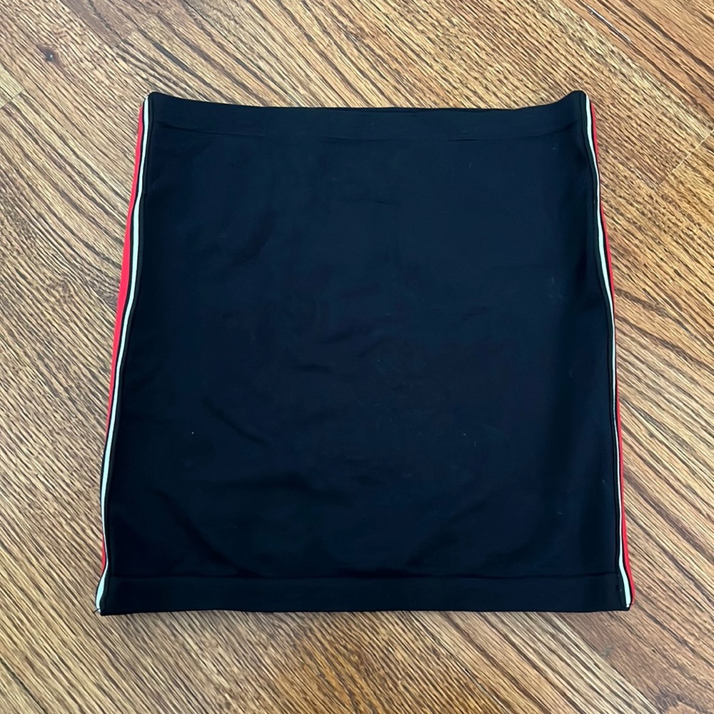 Brand is Suzette, black tube top with red and white stripes on the sides